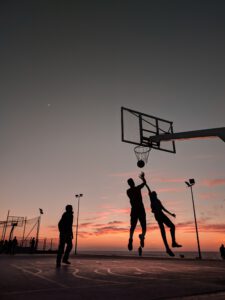 Basketballer auf einem Freiplatz bei Sonnenuntergang